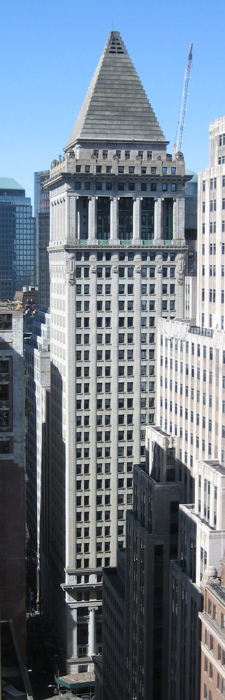The Bankers Trust Building at 14 Wall Street, New York, seen from above: a slender tower crowned by its distinctive stepped pyramid roof.